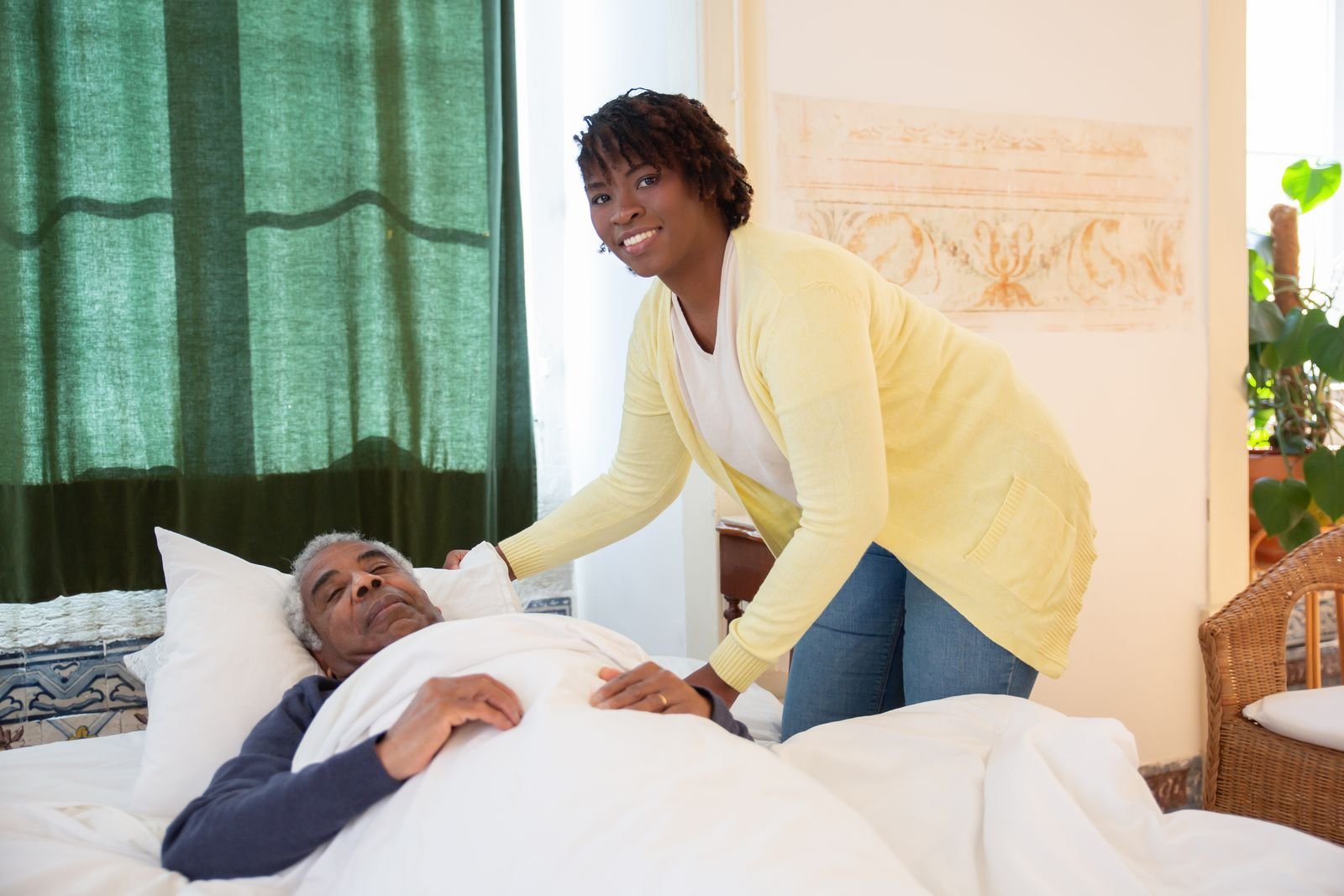 A caregiver assisting an older adult with daily activities at home