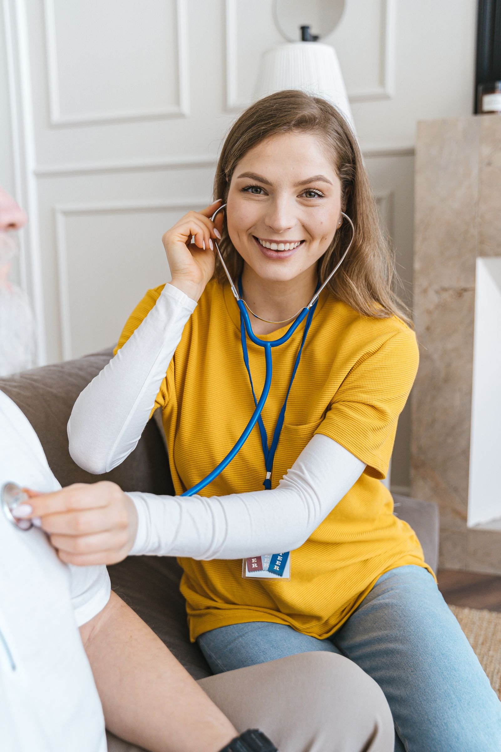 A visiting nurse checking on a senior during a home visit